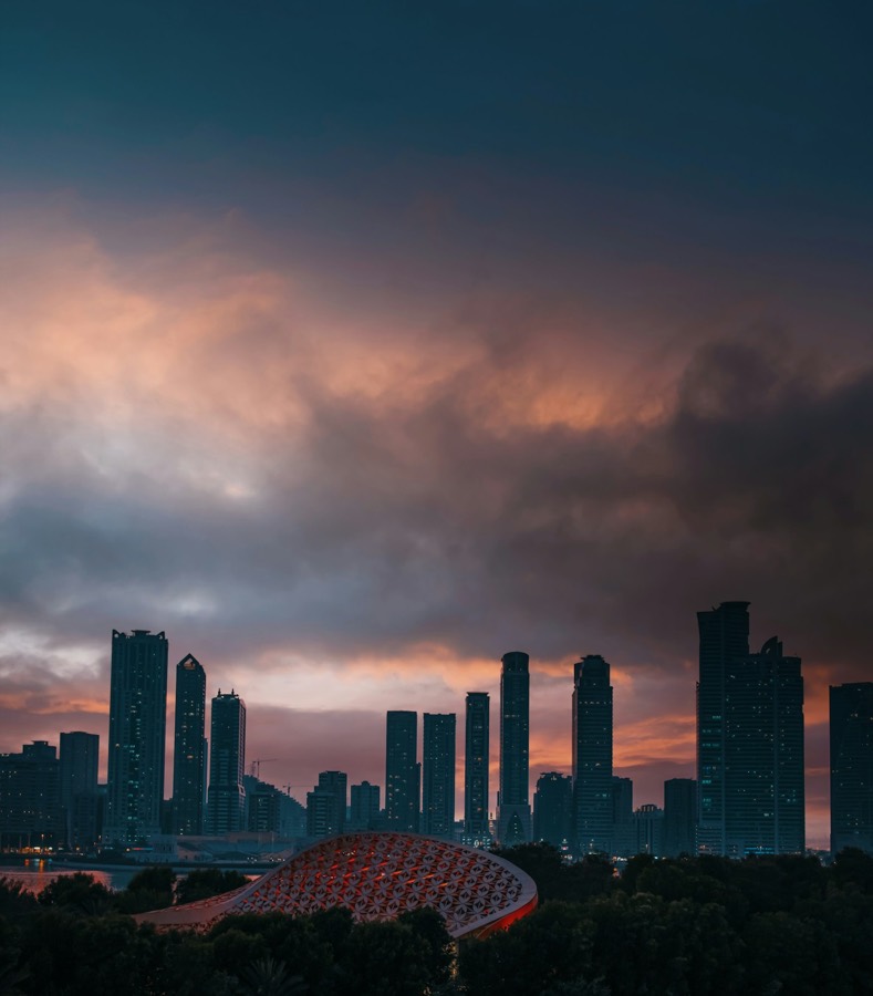 The Sharjah skyline at sunset above the Khalid Lagoon